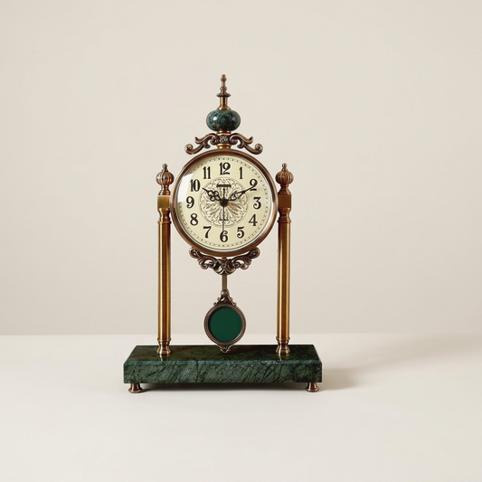 Tall marble and metal desk clock with green marble finial on a neutral background